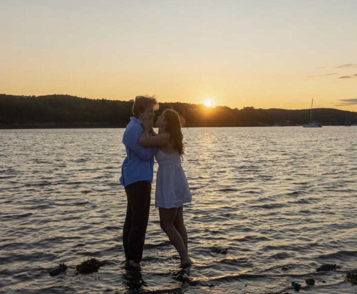 William and Dorrie standing in the shallows at sunset