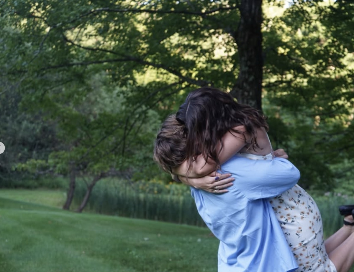 William lifting Dorrie in a field
